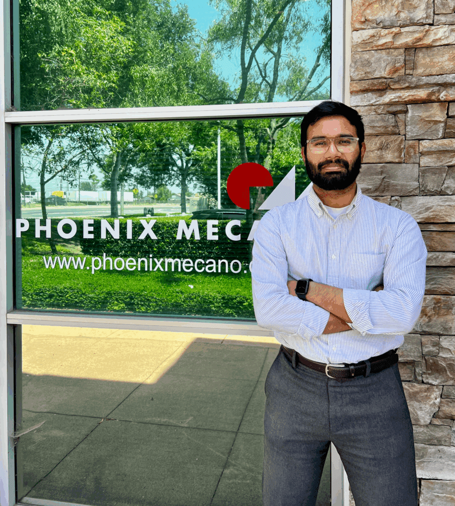 Vignesh Viswanathan standing outside with his arms folded